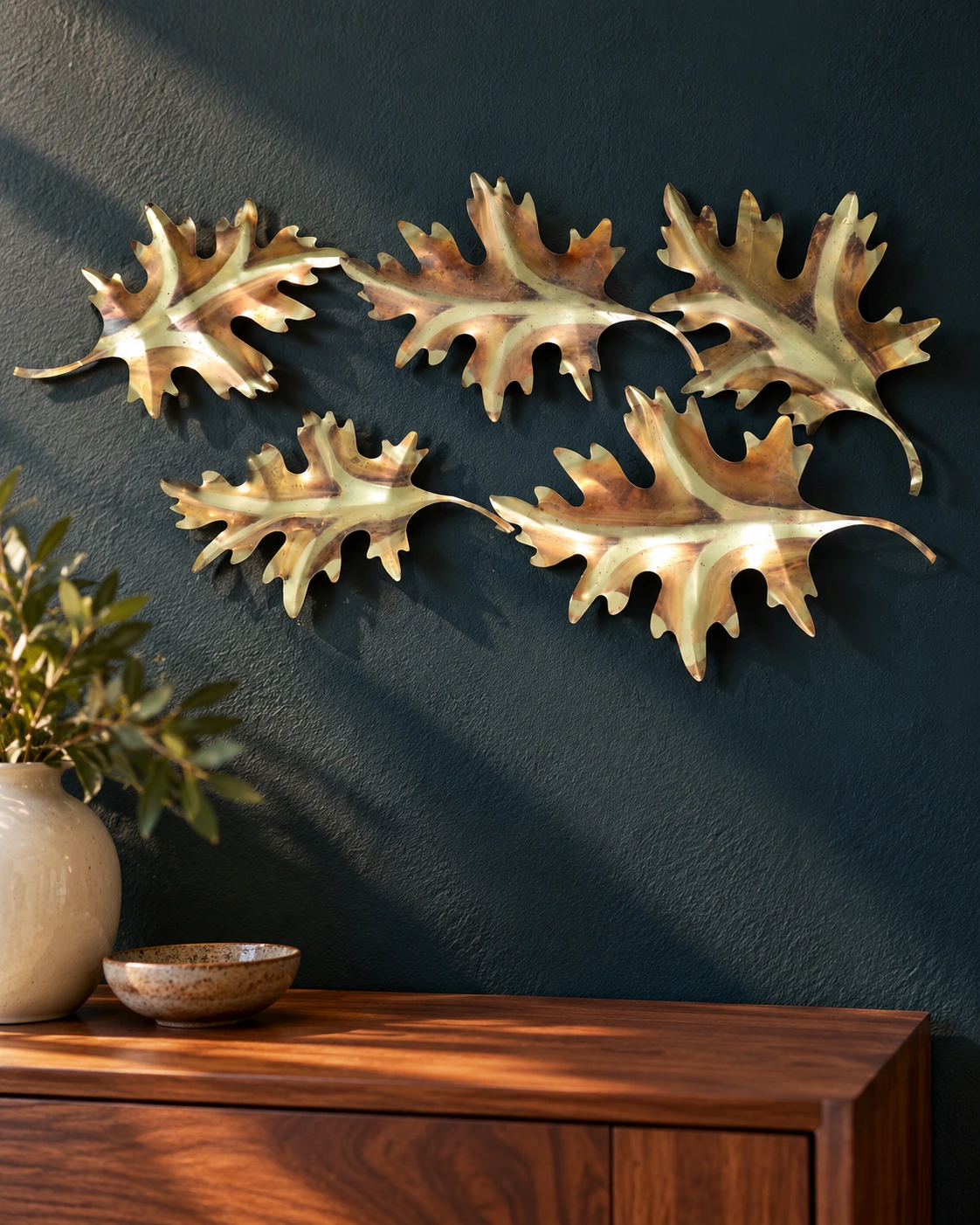 Five gold tone oak leaves above console